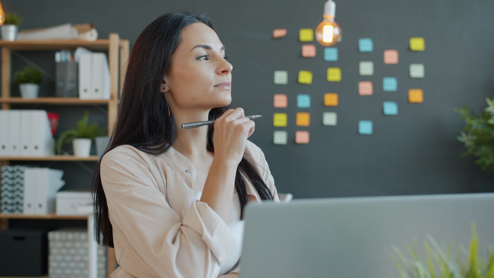 Businesswoman thinking and working in a naturally lit office
