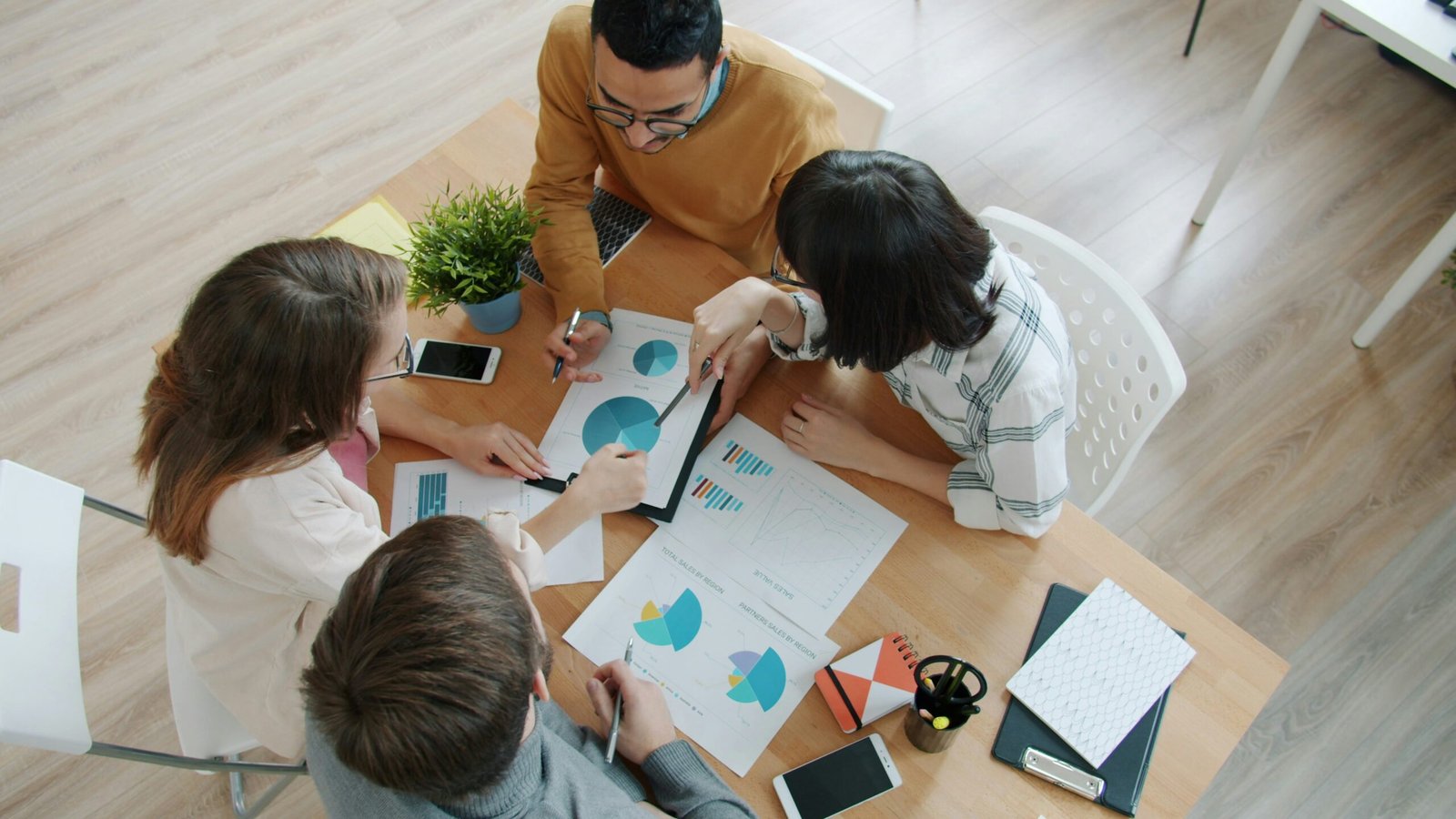 Diverse international business team collaborating around a table in a modern office